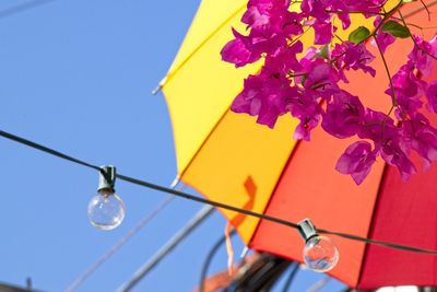 Low angle view of light bulb against blue sky