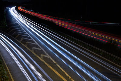 High angle view of light trials on road at night