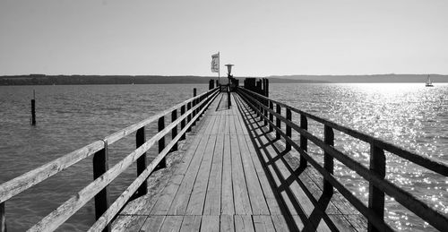 Pier over sea against clear sky