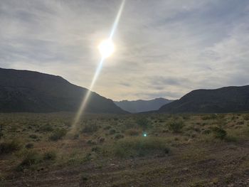 Scenic view of landscape and mountains against sky