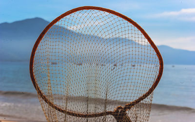 Close-up of fishing net on beach