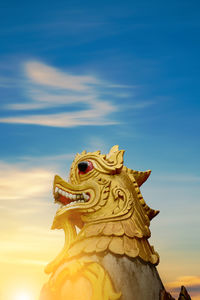 Golden lion sculpture with beautiful sky on the mountain in phra that doi kong mu temple thailand
