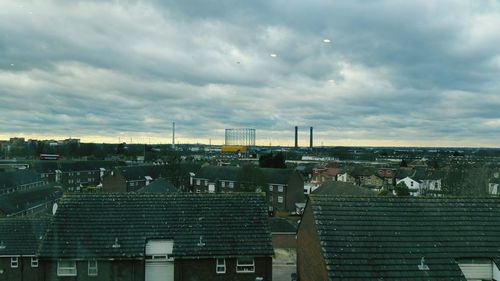 Cityscape against cloudy sky