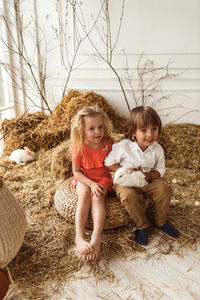 Easter kids playing with rabbits and ducks