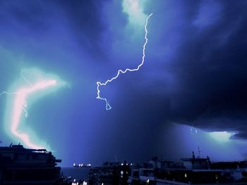 Lightning in sky over city at night