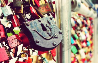 Colorful padlocks attached to railing