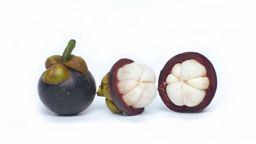 Close-up of fruits against white background
