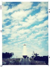 Low angle view of building against cloudy sky