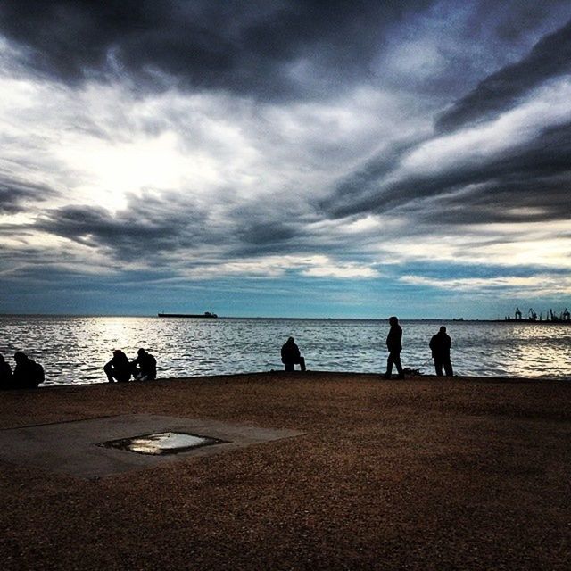 sky, water, sea, cloud - sky, beach, horizon over water, tranquil scene, scenics, tranquility, beauty in nature, cloudy, silhouette, shore, nature, cloud, leisure activity, men, idyllic, lifestyles