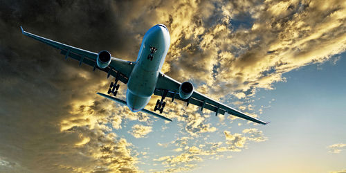 Low angle view of airplane flying against sky