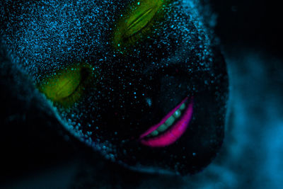 Woman with eyes closed in neon make-up