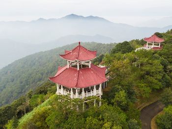 Traditional windmill on mountain against sky