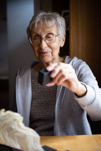 Portrait of senior citizen celebrating her 80th. 