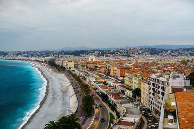 High angle view of buildings by sea against sky