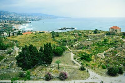 High angle view of sea and buildings against sky