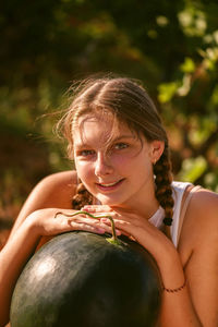 Happy smiling girl with half red fresh watermelon enjoying summer life outdoors. summer lifestyle