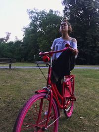 Woman riding bicycle on field