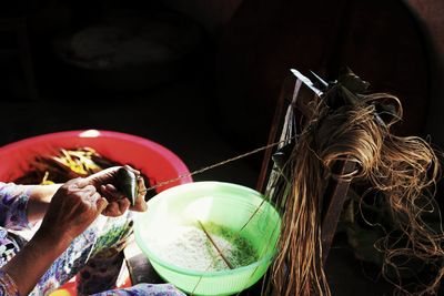 Midsection of woman packing food with rope