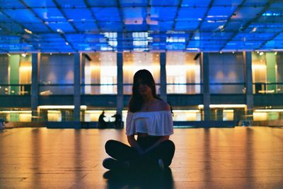 Portrait of woman sitting on floor