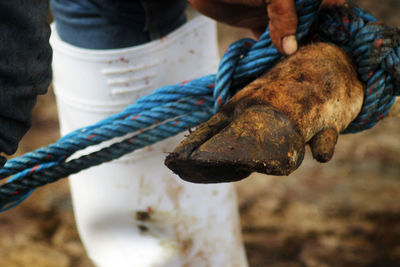 Close-up of man working with rope