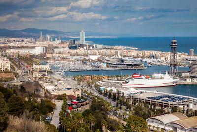 High angle view of buildings by sea against sky