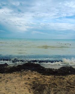 Scenic view of sea against cloudy sky