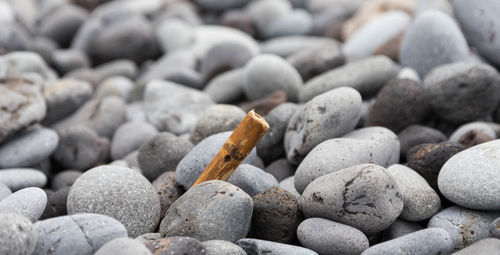 Close-up of cigarette on pebbles
