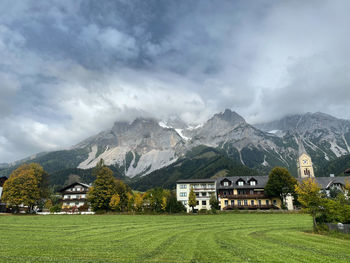 Scenic view of houses and mountains against sky