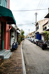 Street amidst buildings in city against sky