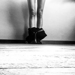 Low section of woman standing on tiled floor