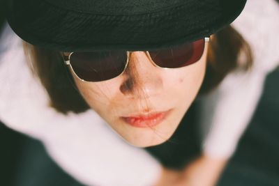 Close-up portrait of young woman wearing sunglasses