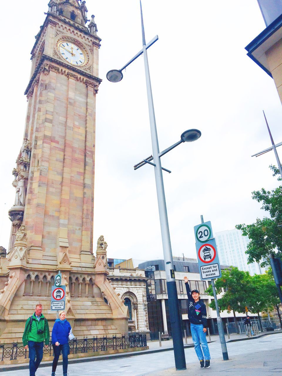 architecture, built structure, building exterior, city, real people, group of people, building, street, tower, sky, travel, day, travel destinations, communication, low angle view, clock tower, tourism, nature, lifestyles, city life, clock