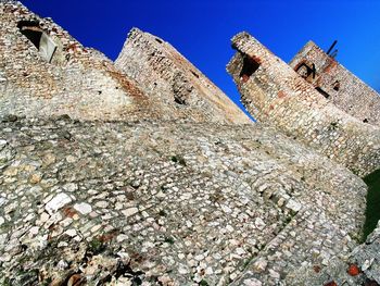 Low angle view of historic building against blue sky