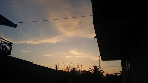 Low angle view of silhouette building against sky during sunset