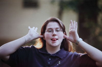 Portrait of woman making silly gesture