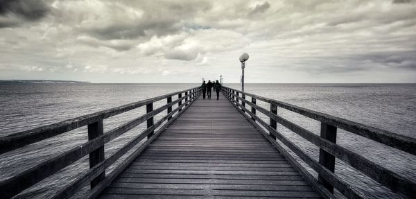 Pier over sea against sky