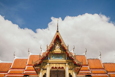 Low angle view of temple building against cloudy sky