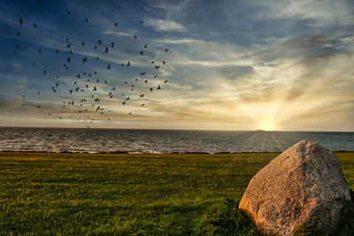Scenic view of sea against sky during sunset