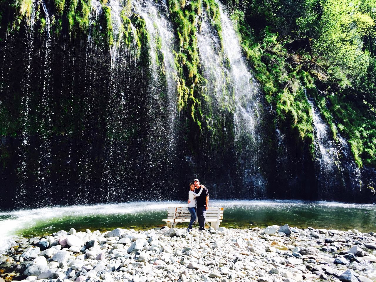 water, lifestyles, leisure activity, motion, rock - object, full length, rear view, splashing, standing, nature, men, flowing water, waterfall, day, person, beauty in nature, outdoors, casual clothing