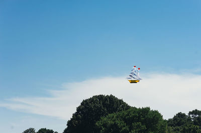 Low angle view of kite against blue sky