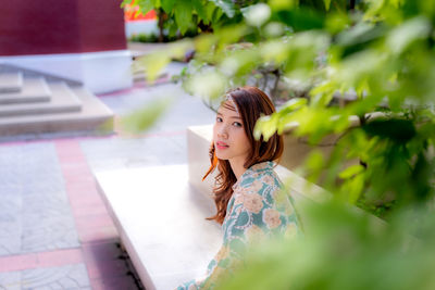 Side view of young woman looking away outdoors