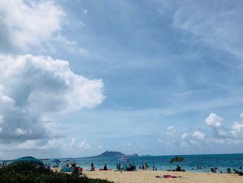 People on beach against sky