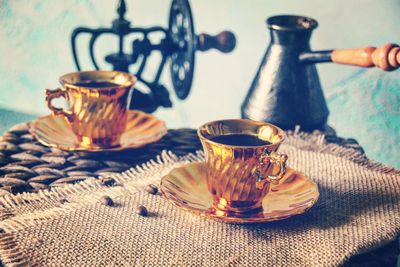 Close-up of coffee served in golden cups