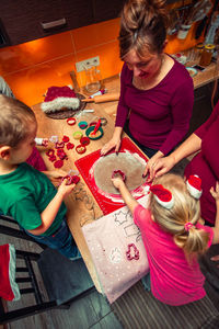 Woman preparing food with children at home