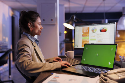 Businesswoman using laptop at office