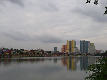 City by river against sky