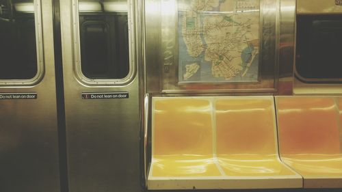Empty yellow seats in illuminated train