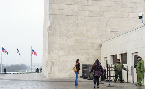 Woman standing in front of built structure