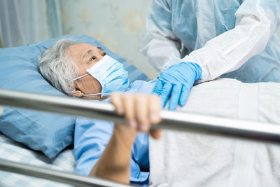 Midsection of woman lying on bed