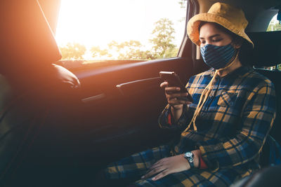 Man using smart phone in car